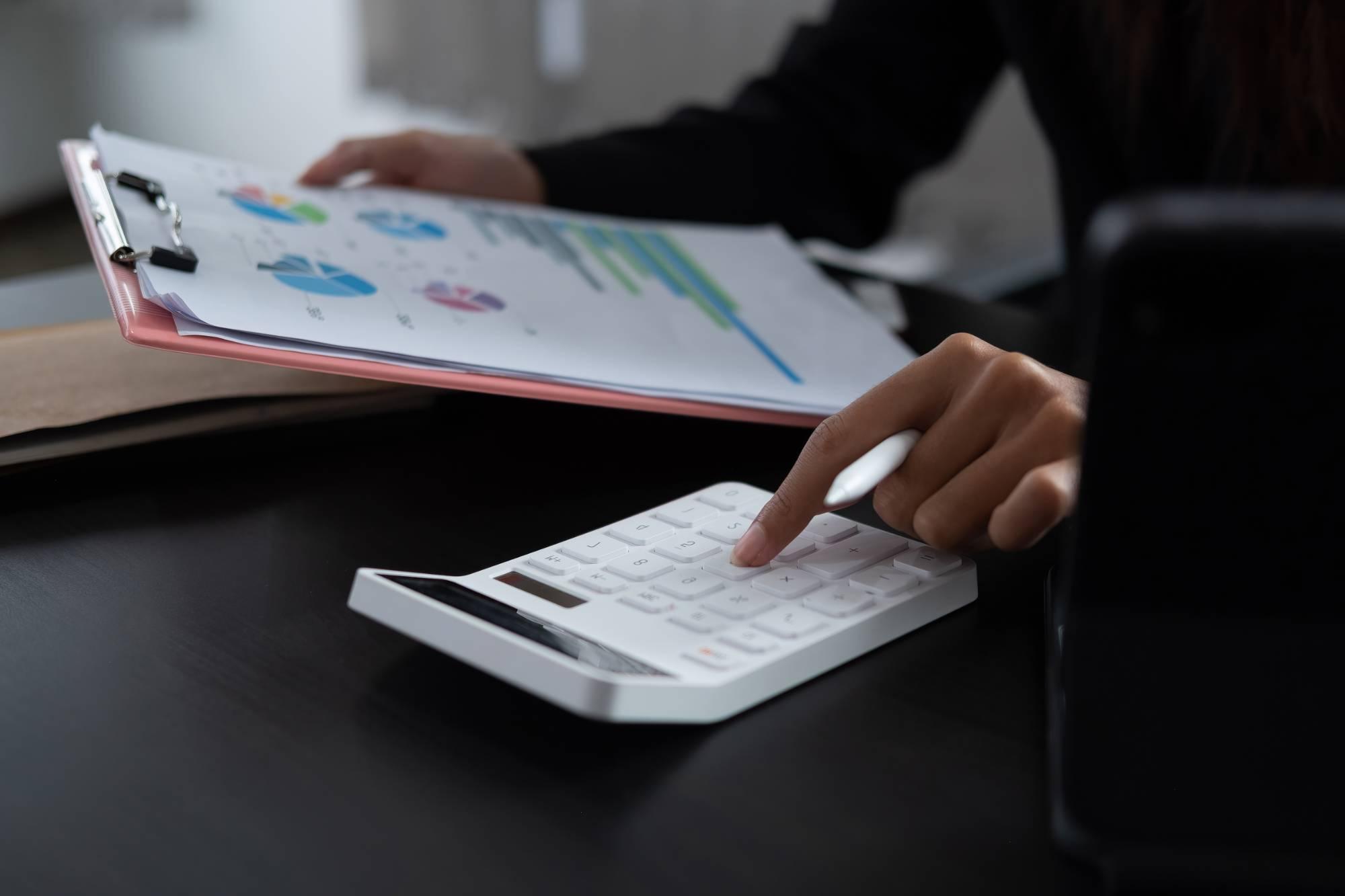 woman with calculator and clip board